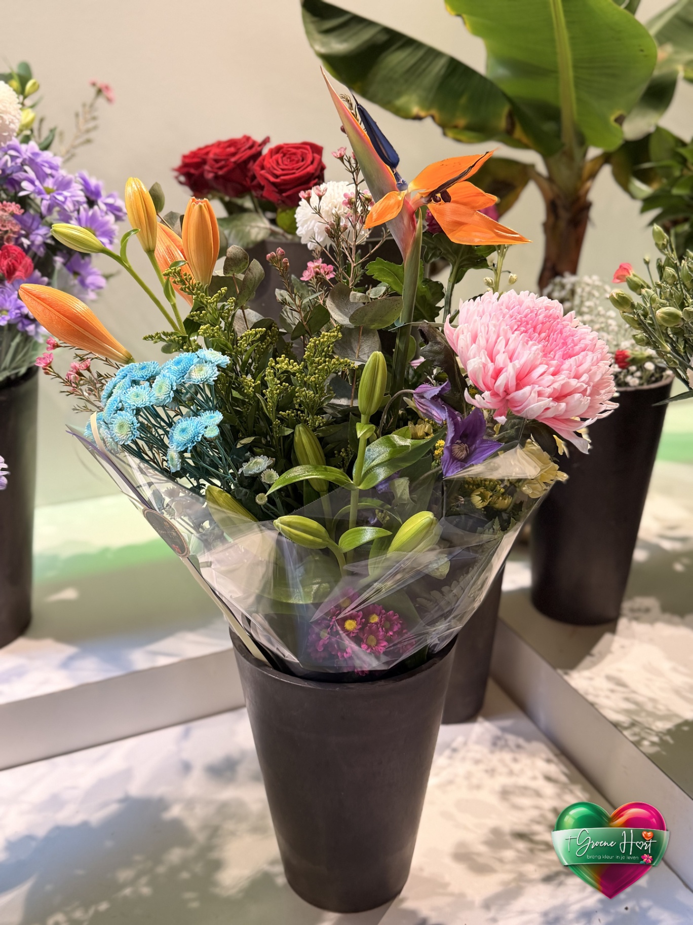 Exotisch boeket met paradijsvogelbloem, lelies en blauwe chrysanten
