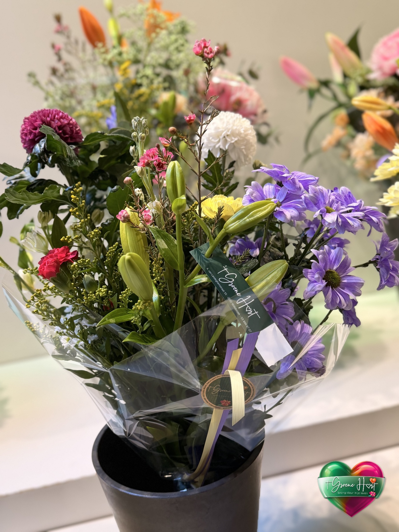 Speels paars-oranje boeket met lelies en margrietjes